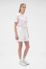Profile view of model wearing the Oroton Flat Front Carpenter Short in Antique White and 100% cotton fabric for Women .