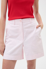 Profile view of model wearing the Oroton Flat Front Carpenter Short in Perfect Pink and 100% cotton fabric for Women .