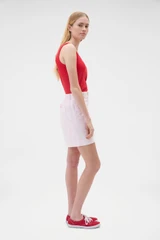 Profile view of model wearing the Oroton Flat Front Carpenter Short in Perfect Pink and 100% cotton fabric for Women .