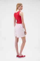Profile view of model wearing the Oroton Flat Front Carpenter Short in Perfect Pink and 100% cotton fabric for Women .