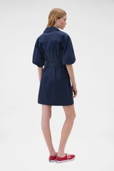 Profile view of model wearing the Oroton Washed Drill Dress in North Sea and 100% cotton fabric for Women .