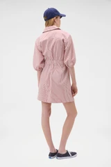 Profile view of model wearing the Oroton Railroad Drill Dress in Robbin Red and 100% cotton fabric for Women .