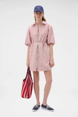 Profile view of model wearing the Oroton Railroad Drill Dress in Robbin Red and 100% cotton fabric for Women .