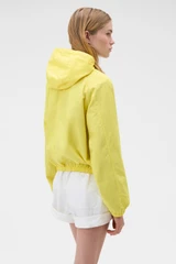 Profile view of model wearing the Oroton Weekend Windbreaker in Daffodil and 100% cotton fabric for Women .