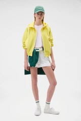 Profile view of model wearing the Oroton Weekend Windbreaker in Daffodil and 100% cotton fabric for Women .