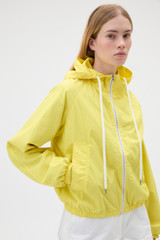 Profile view of model wearing the Oroton Weekend Windbreaker in Daffodil and 100% cotton fabric for Women .