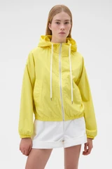 Profile view of model wearing the Oroton Weekend Windbreaker in Daffodil and 100% cotton fabric for Women .