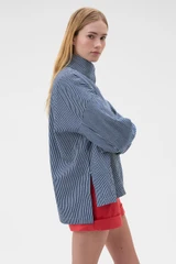 Profile view of model wearing the Oroton Washed Weekend Stripe Parka in Dark Navy and 100% cotton fabric for Women .