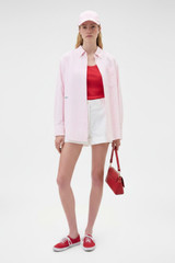 Profile view of model wearing the Oroton Oxford Stripe Shirt in Perfect Pink and 100% cotton fabric for Women .