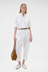 Profile view of model wearing the Oroton Oxford Shirt in Antique White and 100% cotton fabric for Women .