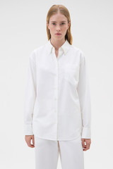 Profile view of model wearing the Oroton Oxford Shirt in Antique White and 100% cotton fabric for Women .