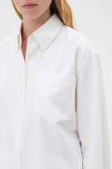 Profile view of model wearing the Oroton Oxford Shirt in Antique White and 100% cotton fabric for Women .