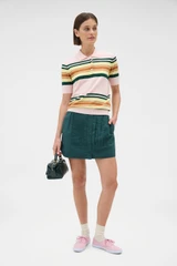 Profile view of model wearing the Oroton Multi Stripe Knit Polo in Multi and 100% cotton fabric for Women .