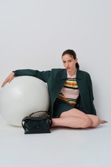 Profile view of model wearing the Oroton Multi Stripe Knit Polo in Multi and 100% cotton fabric for Women .