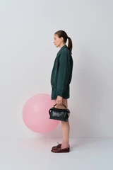 Profile view of model wearing the Oroton Pleated Bomber Shirt in Neptune Green and 100% cotton poplin fabric for Women .