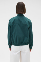 Profile view of model wearing the Oroton Pleated Bomber Shirt in Neptune Green and 100% cotton poplin fabric for Women .